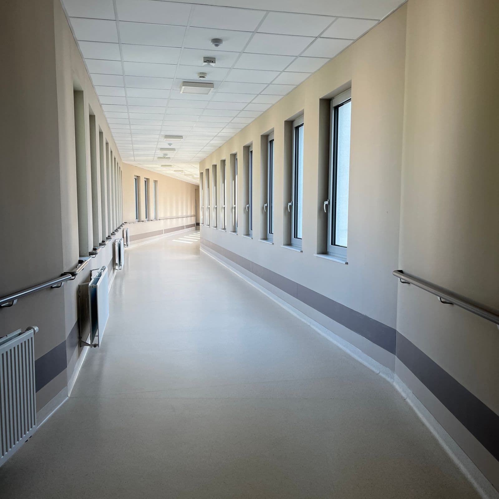 Modern clinic corridor with clean flooring and bright lighting