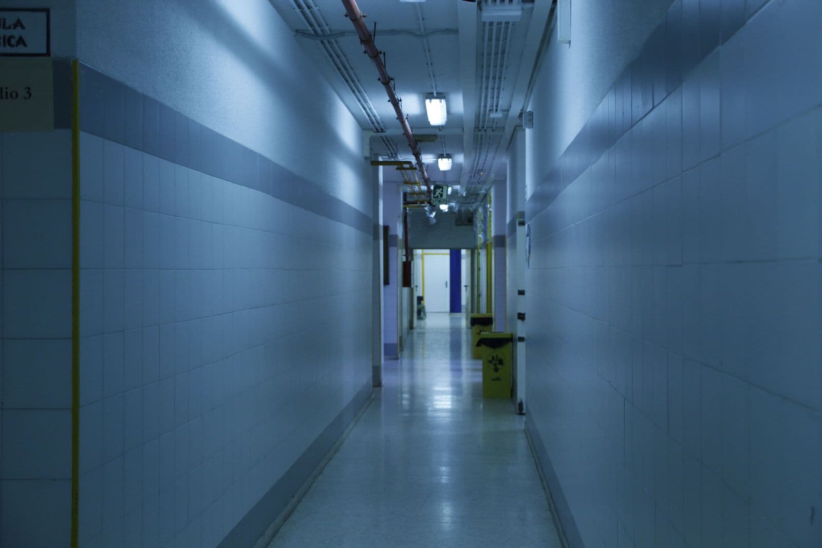 Bright clinic hallway interior leading to private treatment rooms